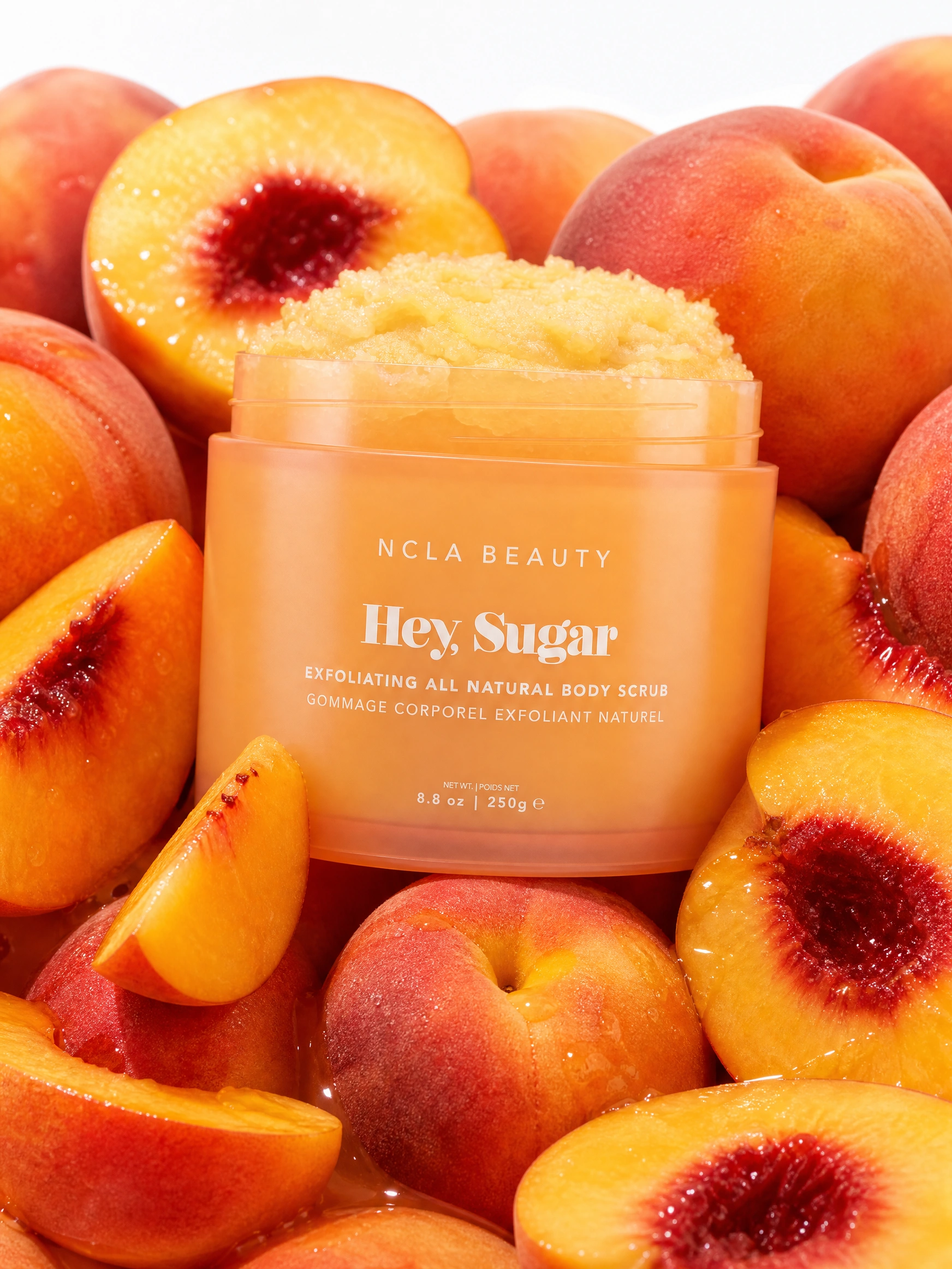 NCLA Beauty Hey Sugar scrub surrounded by peaches